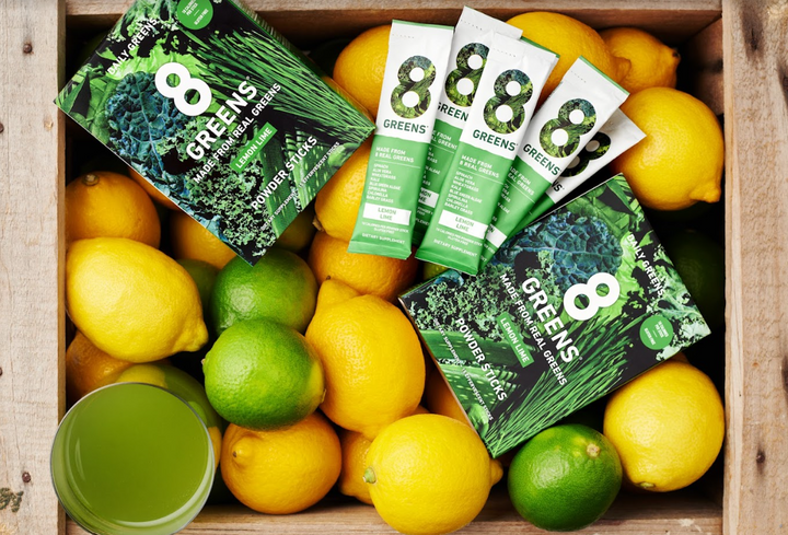lifestyle image of the powder sticks with lemons and lime fruits