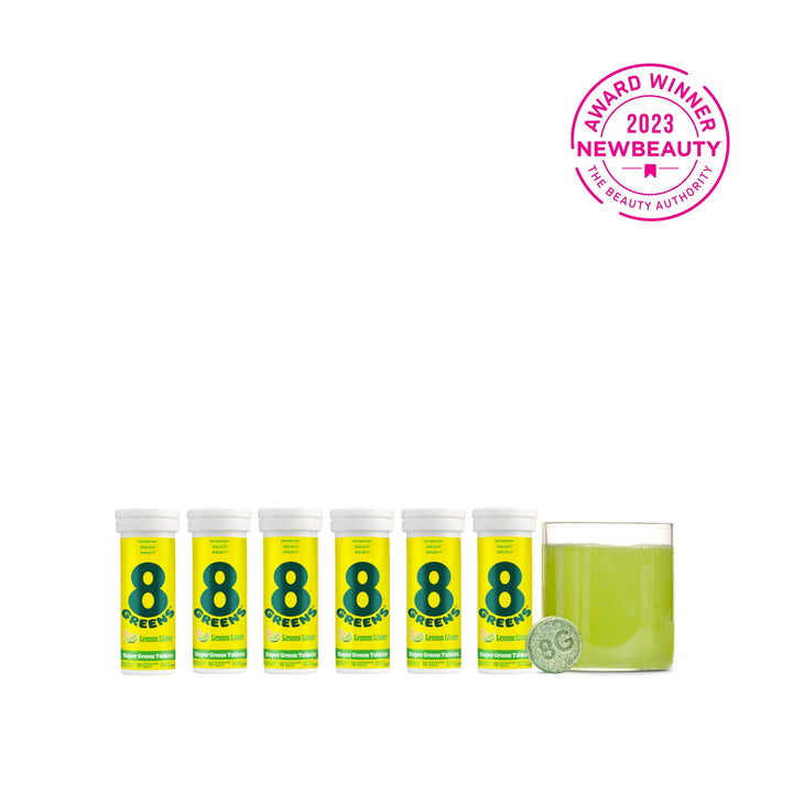 6 packs on Super Greens Tablets, one tablet and green drink prepared in glass in flavor lemon lime
