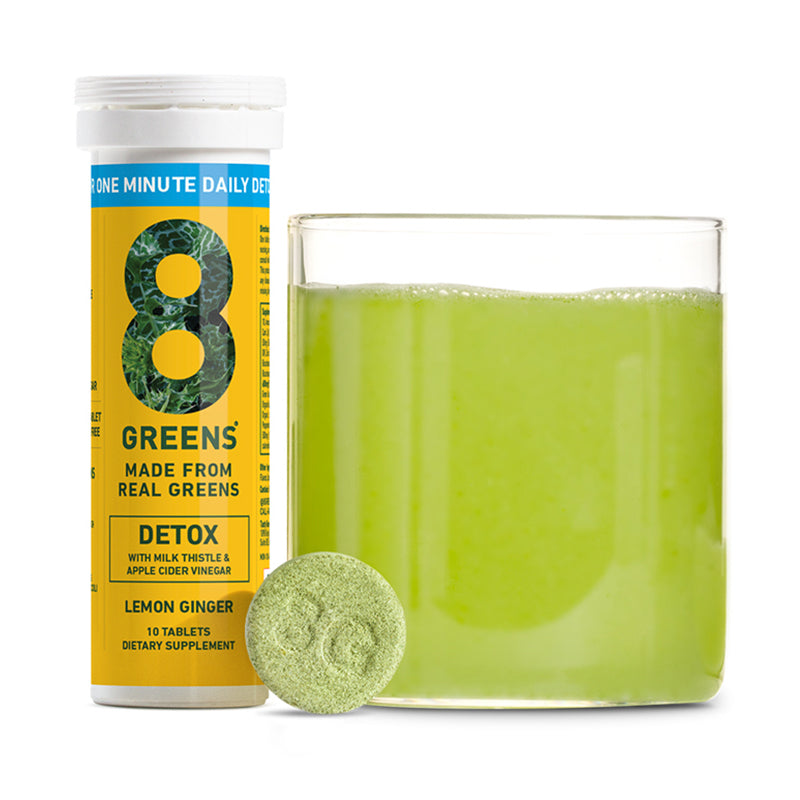8Greens Detox tablets lemon ginger next to green juice in glass